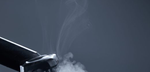 Horizontal shot of steam close-up. Steam carpet cleaning on a grey background. Photo from copy space.